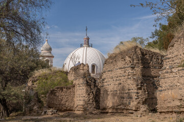 rural church behind ruined houses