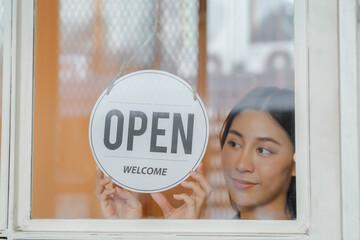 Smiling young asian business owner, employee retail,coffee shop woman,girl turning,setting sign...
