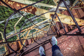 Tourist climbing on old Soviet Duga radar in abandoned military base in Chernobyl Exclusion Zone, Ukraine