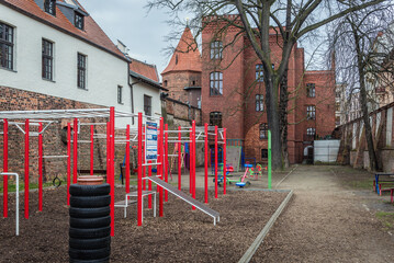 Fototapeta na wymiar Outdoor gym in the moat of Teutonic Castle in historic part of Torun city, Poland