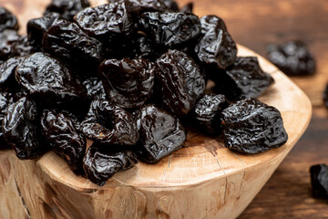 Dried prunes on a wooden background. Dry fruits.
