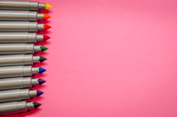 Multicolored markers or felt-tip pens isolated on pink background. Drawing and hobby concept