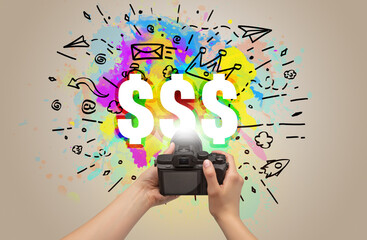 Close-up of a hand holding digital camera with abstract drawing concept