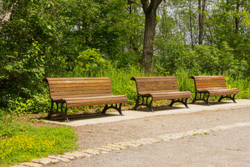 Three wooden park benches