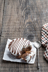 decorated sponge cake on wooden table with cup of coffee and spoon