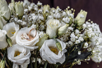 hands of young people with wedding wedding rings. wedding day details. calla flowers. spouses newlyweds groom and bride