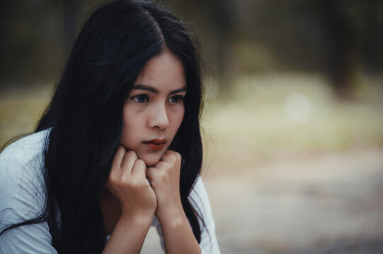 Beautiful thai woman very sad from unrequited love,She rethink and think over about love,vintage style,dark tone,broken heart,asian girl