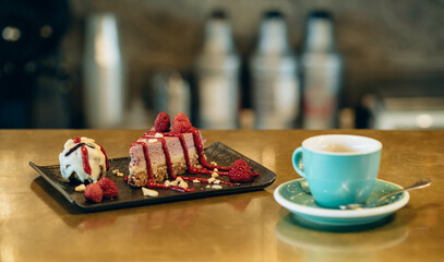 A Slice of Raspberry Cake and Cup of Espresso Coffee on Golden Bar Counter