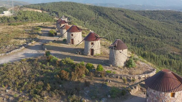 Aerial view The ancient windmills, Portugal. This is typical windmills, located in the on the hills in Portugal.
Circular tower mill has four trapezoidal sails made of wood. The four lattice framework