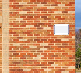 Blank sign on a brick wall.
