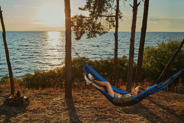 Backpacker is having a rest in hammock