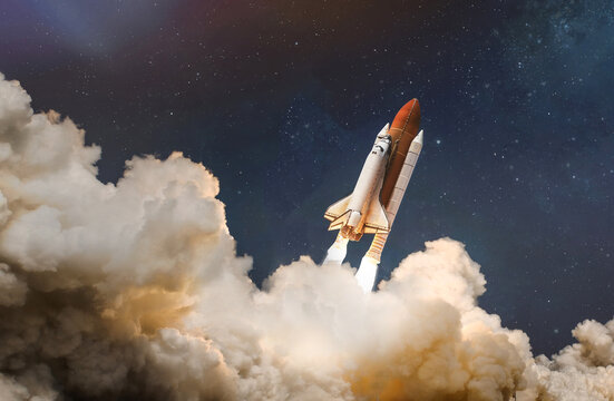 Space shuttle launch in the clouds to outer space. Dark space with stars on background. Sky and clouds. Spaceship flight. Elements of this image furnished by NASA