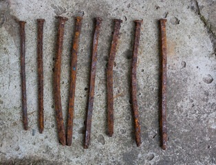 Rusty nails on the background of old concrete.