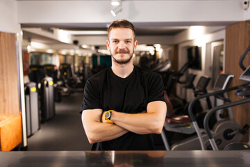 muscular boy posing in a generic out of focus fitness club