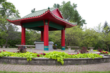 Red Asian Temple with Flowers in a Cemetery