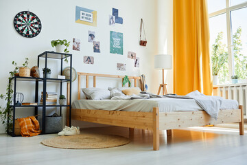 Background image of cozy teenage bedroom with a lot of accessories and comfortable bed, copy space