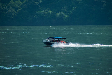 Fototapeta premium Cruise ship for tourists who come to see the Danube river. Tourists admire the landscapes of the Danube.Romaniam, Orsova. July, 18, 2021
