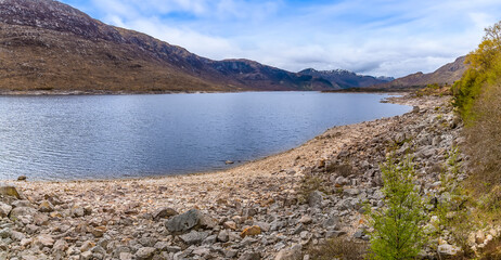A view along the shoreline of Loch Cluanie, Scotland on a summers day