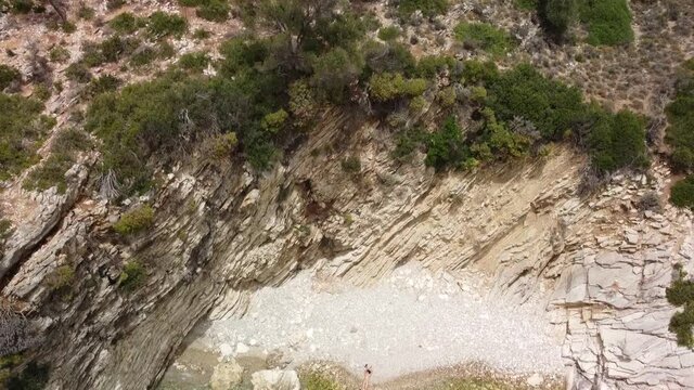 aerial shot kalamos island beach with model sunbathing , lefkada, greece