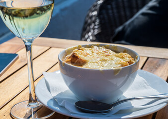 French caramelized onion soup with croutons and gruyere cheesse from oven