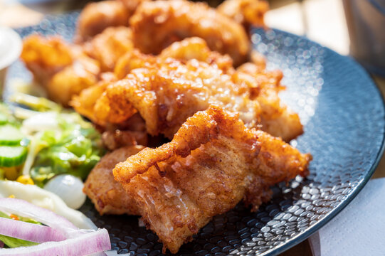 Dutch street food, fried pieces of cod fish fillet served with garlic sauce and fresh green salade