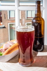 Drinking dark beer with smoked eel fish sandwich with view on street in old Zierikzee town, Zeeland, Netherland