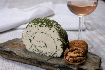 Cheese collection, fresh white soft goat French cheese roll with aromatic herbs and chives