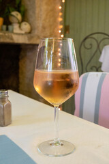 Summer on French Riviera Cote d'Azur, drinking cold rose from Cotes de Provence on outdoor terrase in old cafe, Var, France
