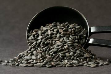 Black Sesame Seeds Spilled from a Teaspoon