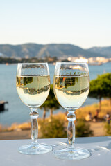 Summer on French Riviera, drinking cold white wine from Cotes de Provence on outdoor terrase with view on harbour of Toulon, Var, France