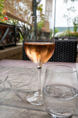 Summer on French Riviera Cote d'Azur, drinking cold rose  wine from Cotes de Provence on outdoor terrase in cafe