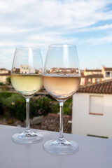 Summer on French Riviera Cote d'Azur, drinking cold rose and white wine from Cotes de Provence on outdoor terrase in Port Grimaud, Var, France