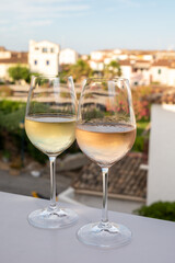 Summer on French Riviera Cote d'Azur, drinking cold rose and white wine from Cotes de Provence on outdoor terrase in Port Grimaud, Var, France