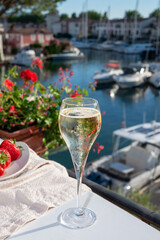 Summer party, pouring of French champagne sparkling wine in glasses in yacht harbour of Port Grimaud near Saint-Tropez, French Riviera vacation, France