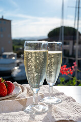 Summer party, pouring of French champagne sparkling wine in glasses in yacht harbour of Port Grimaud near Saint-Tropez, French Riviera vacation, France