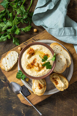 Middle Eastern, Hummus Arabic Cuisine. Vegetarian dips Homemade chickpea hummus with olive oil, paprika on a rustic table. Top view flat lay background.