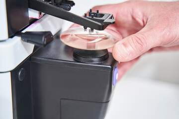 Male optician using modern optical equipment in workshop
