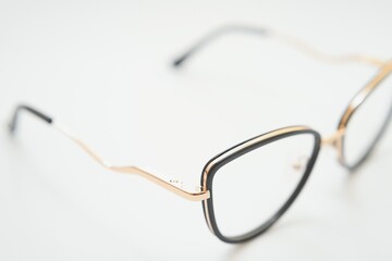 Female eyeglasses macro detail over a white background. Horizontal