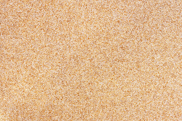 Fototapeta na wymiar background of disseminated sand small gravel, a stone crumb. Texture of a surface of a wall, light color
