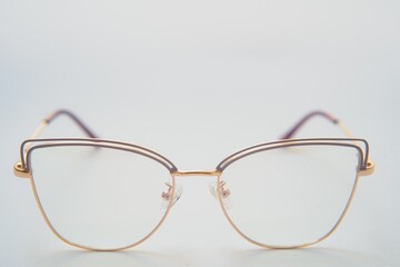 Female eyeglasses macro detail over a white background. Horizontal