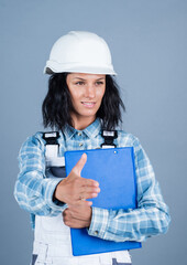greeting or welcome. girl in workshop uniform. engineering. architect working with folder. female foreman on construction site. carpenter assistant wear protective helmet