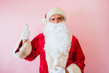 Man dressed as Santa Claus making positivity gesture with finger up
