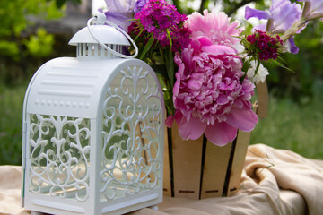 here are white lamp,fresh flowers on the table.