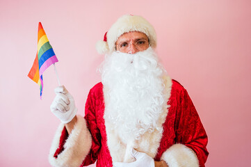 Man dressed as Santa Claus holding a multicolored flag