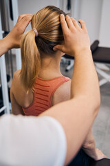 Manual therapist checks woman head in rehab clinic closeup back view. Chiropractic. Healthcare