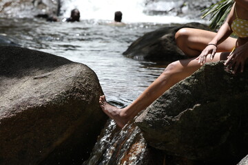 Woman in bikini on rocks