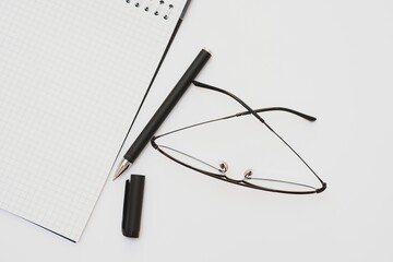 Fountain pen notebook and glasses in composition in black and white