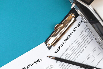 Vechile power of attorney form. Office desk and clipboard with agreement. Top view photo