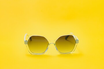 yellow sunglasses on yellow background