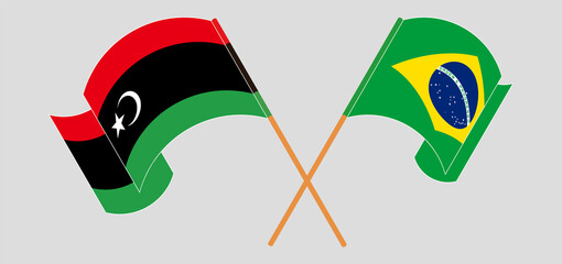 Crossed and waving flags of Libya and Brazil